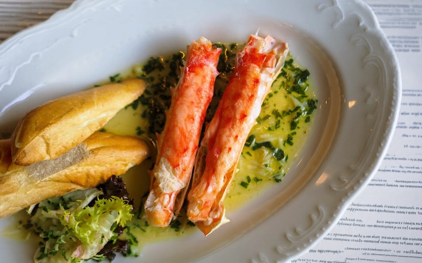 Crab meat on a plate with a piece of bread.