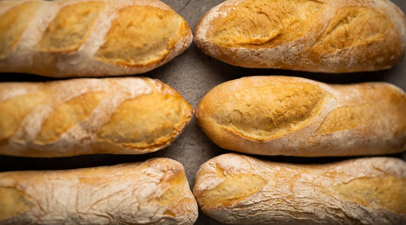 Multiple baguettes fresh out of the oven.