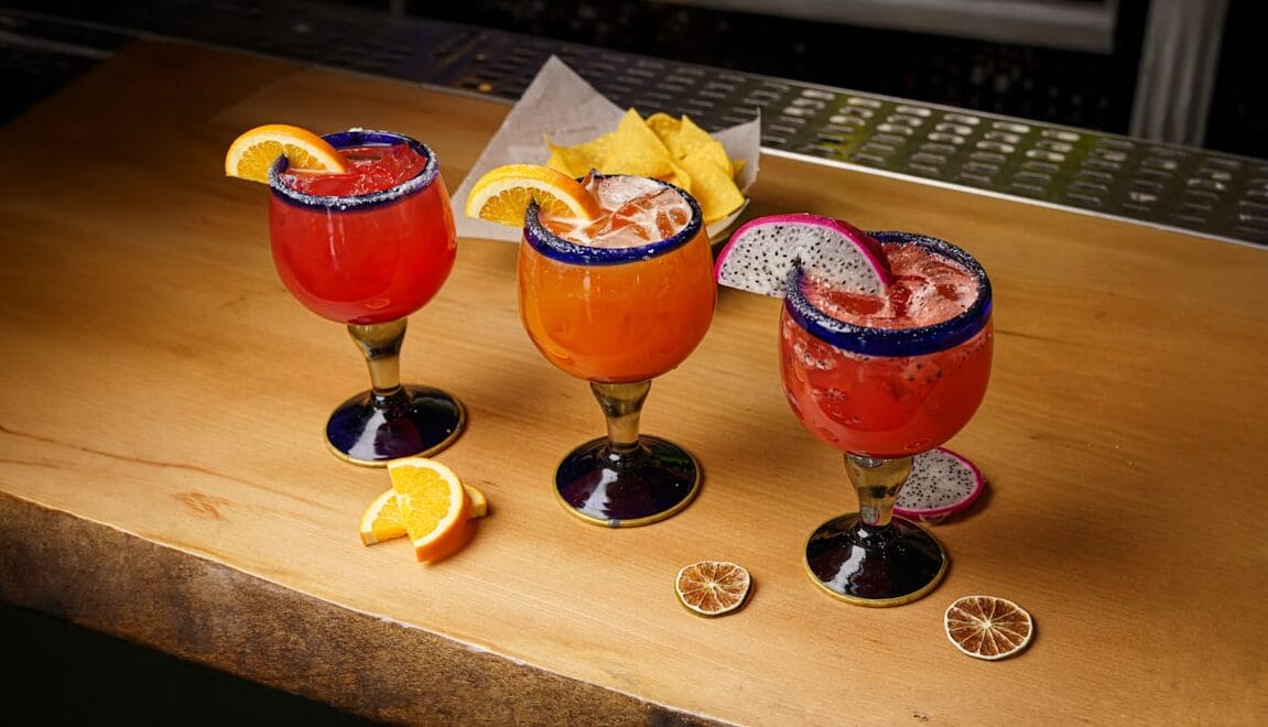 Three Margaritas on a table.