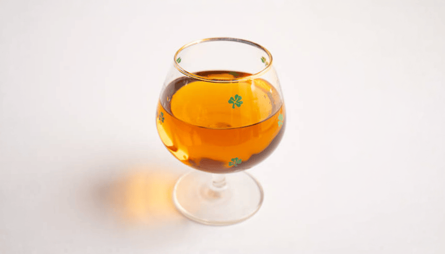 Irish Whiskey in a cup on a table.